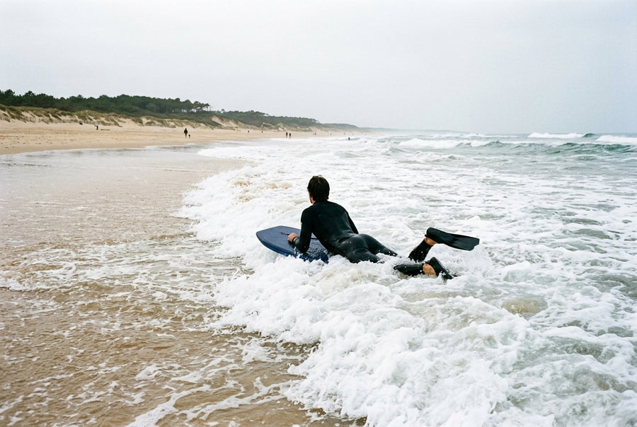 Beginner bodyboarder in the whitewater on a Landes beach