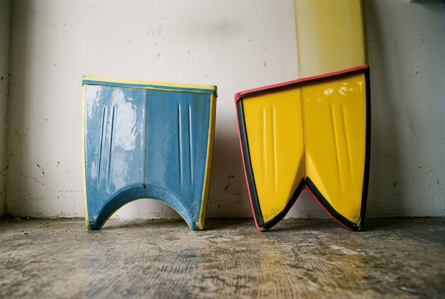 Crescent tail and bat tail on two bodyboards, seen from below