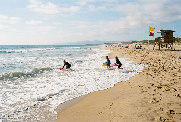 Small, regular whitewater on a lifeguarded sandy beach, ideal conditions to start bodyboarding